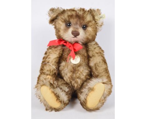A boxed Steiff replica 1926 teddy bear (smaller version) no.407215, with numbered white and black tag to ear, with brown tipp