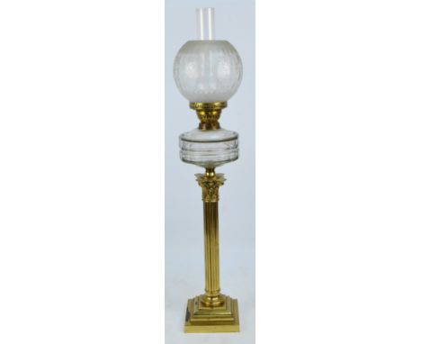 A brass Corinthian column table lamp with clear glass reservoir, etched shade and stepped base, height including chimney 95cm