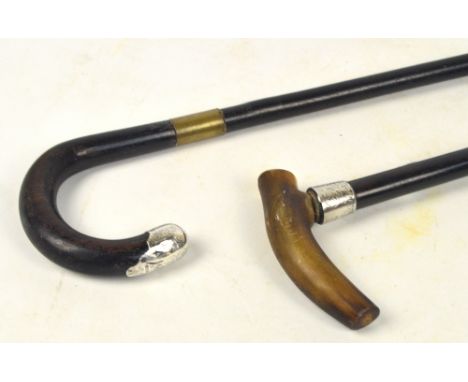 An ebonised shafted horn handled walking stick with silver collar, and a further walking stick with silver mount (2). CONDITI
