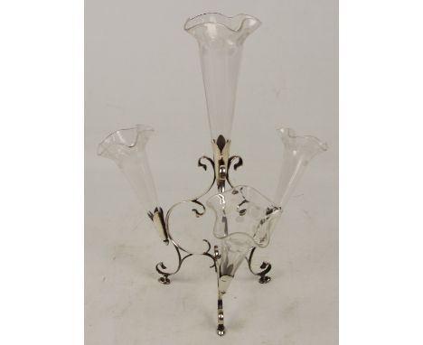 A George V hallmarked silver scroll openwork decorated epergne with four apertures and clear etched glass liners, on three ho