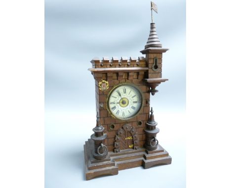 GERMAN MANTEL CLOCK, castellated form with turrets, the enamelled dial set with Roman numerals before a mixed metal bell stri