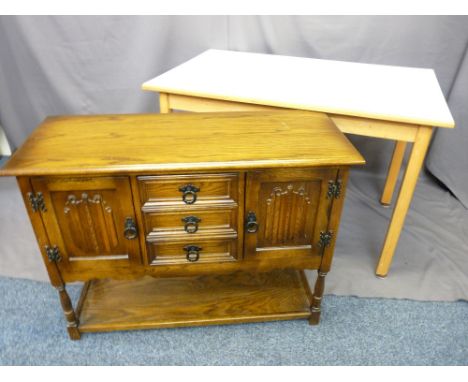 PRIORY-STYLE OAK SMALL SIDEBOARD of three central drawers and linen fold carved cupboard doors above an under tier shelf, 68c