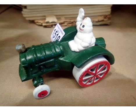 Cast iron Michelin Man on a tractor, H: 80 mm. UK P&amp;P Group 1 (£16+VAT for the first lot and £2+VAT for subsequent lots) 