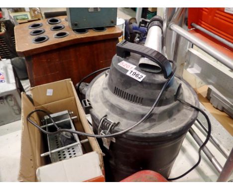 Black vacuum together with a briquette maker. All electrical items in this lot have been PAT tested for safety and have passe