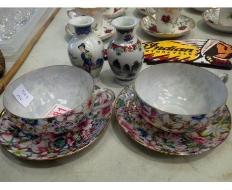 Two Oriental eggshell cups and saucers and two vases. Not available for in-house P&amp;P 