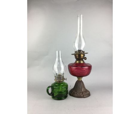 VICTORIAN CAST METAL OIL LAMP, with cranberry glass reservoir, 53cm high to tip of funnel, along with a green glass chamber o