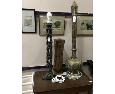 EASTERN BRASS FLOOR LAMP, 102cm high, along with a carved African floor lamp (2)