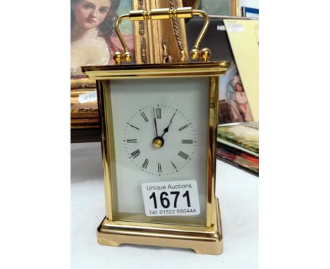 A modern battery brass carriage clock in working order.