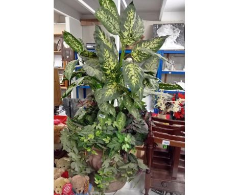A large plastic terracotta style urn planter with display of artificial plants COLLECT ONLY