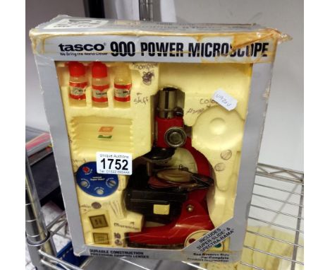 A boxed Tasco 900 power microscope
