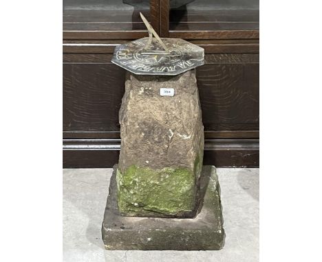 A sundial on free-form stone pedestal. 27' high