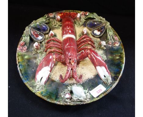 A PALISSY TYPE DISH decorated with a lobster and shells, impressed marks, 31cm diam