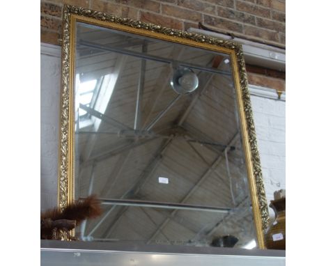 A GILT FRAMED BEVELLED WALL MIRROR, 86cm x 112cm