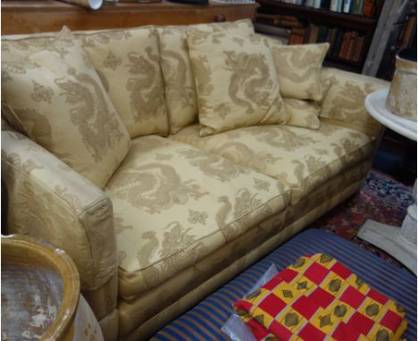 A MODERN KNOLE STYLE SOFA upholstered in champagne coloured Chinese style material decorated with dragons with matching scatt