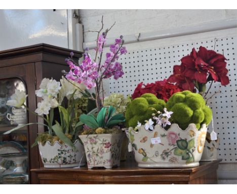 A COLLECTION OF ARTIFICIAL FLOWERS in painted ceramic jardinieres 