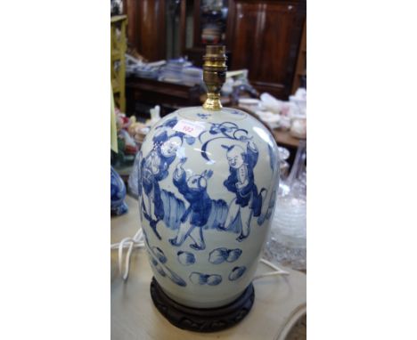 A CHINESE BLUE AND WHITE TABLE LAMP on a carved hardwood stand with brass fittings