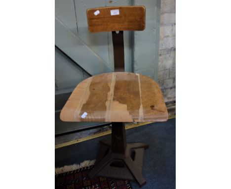 A VINTAGE CAST IRON "SINGER" SWIVEL SEWING MACHINIST'S CHAIR, the square base with "Singer" embossed, supporting a shaped ply
