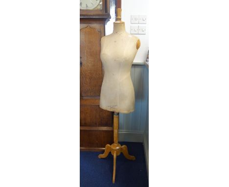 AN EARLY 20TH CENTURY FRENCH DRESS MAKER'S DUMMY / MANNEQUIN, "Buste Girard, Paris" on a wooden tripod stand, 155cm high