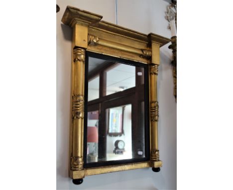 A REGENCY GILT FRAMED OVERMANTLE OR PIER MIRROR, the pilasters with leaf terminals 52cm wide (at cornice)