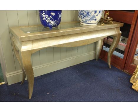 A SILVERED CONSOLE TABLE with inset bevelled glass top and shaped legs, 147cm wide