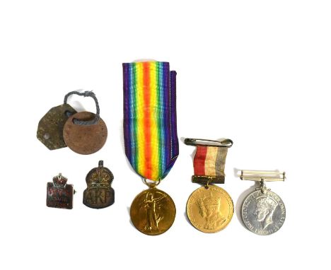 A collection of assorted British campaign medals and badges to include; WWI First World War Victory medal awarded to one 0235
