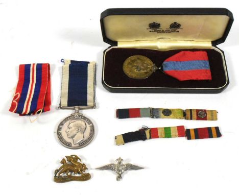 A collection of British Military medals and badges comprising a WWII Second World War Royal Navy For Long Service and Good Co