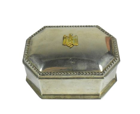 A WWII Second World War Third Reich Nazi German style silver plated trinket box with applied brass eagle swastika badge and a