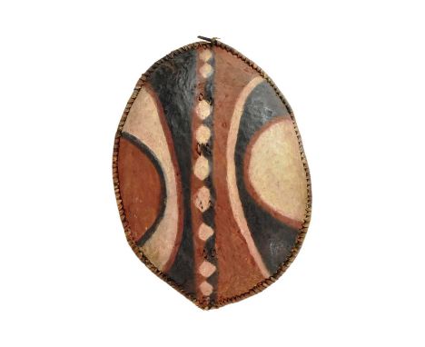 A vintage 20th Century East African Maasai People tribal hunting shield. Buffalo hide reinforced with a clay coating attached
