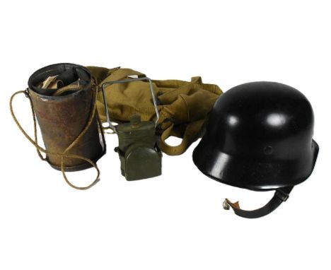 A collection of assorted Militaria comprising; post WWII Second World War German helmet dated 1940 with a later / reproductio