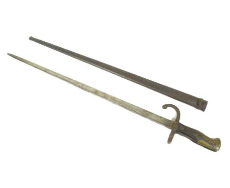 An original 19th Century French 1877 dated Gras rifle bayonet. The hilt with brass pommel and wooden grips encasing the tang 