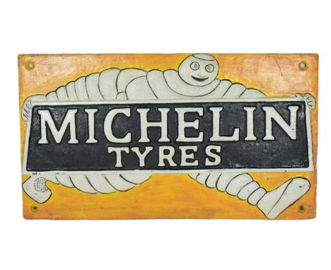 A vintage cast iron Michelin Tyre sign featuring the Bibendum Michelin Man holding a blue and white sign. Dated 1949 to verso