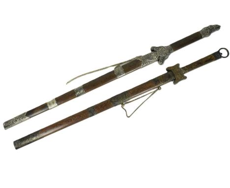 Two contempoary reproduction Chinese double handed broadswords housed in wooden scabbards with carved metal mounts of dragon 