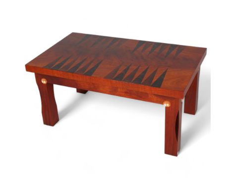 MARK BEVERTON, a contemporary craftsman made coffee table with inlaid backgammon board, with sculptural hollow legs and gilt 