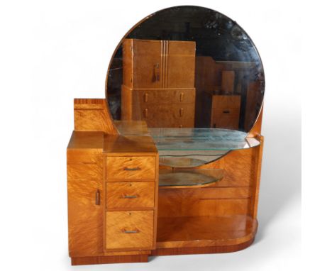 Art Deco satinwood dressing table, circa 1920, circular mirror-back with end cupboard, central 3-drawer section and side shel