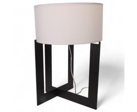 A stylish black painted table lamp, the X form base supporting a white shade, height 61cmGood condition 