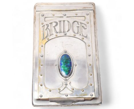 An Art Nouveau electroplate Bridge scoring pad, with hinged cover and inset peacock enamel panel, 18cm x 10cmPlating very sli