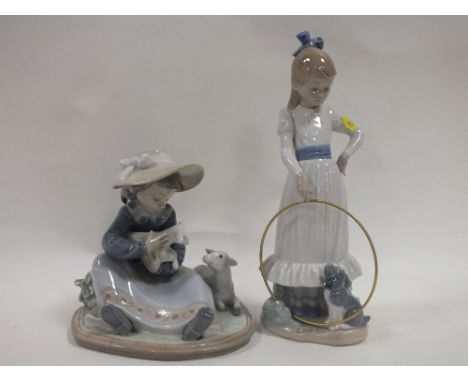 A LLADRO FIGURE OF A YOUNG GIRL HOLDING A LAMB TOGETHER WITH A NAO FIGURE OF A GIRL WITH A HULA HOOP AND DOG A/F