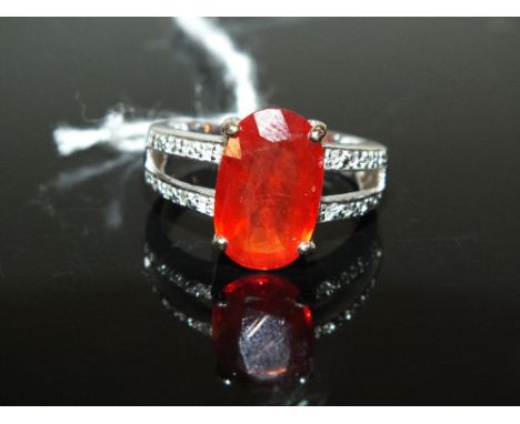 AN 18 CARAT WHITE GOLD FIRE OPAL AND DIAMOND RING, set with a Mexican Fire opal type central stone of an estimated 5 carats, 