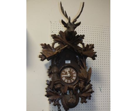 A VINTAGE CARVED BLACKFOREST STYLE HUNTING THEME CUCKOO CLOCK WITH WEIGHTS &amp; KEY 