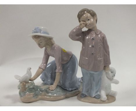 A NAO FIGURE OF A GIRL WITH A BIRD ON A BRANCH TOGETHER WITH A NAO FIGURE OF A BOY WITH A TEDDY BEAR (2) 