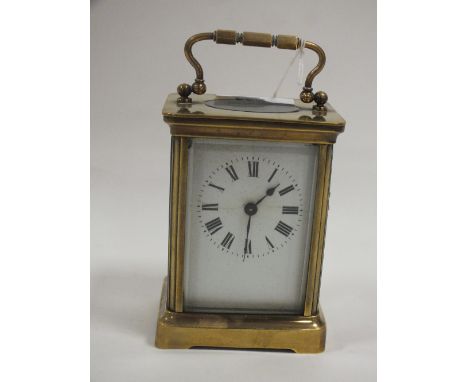 A SMALL BRASS CASED DUVERDREY &amp; BLOQUEL CARRIAGE CLOCK, the enamel dial with Roman numerals, the movement with lion backs