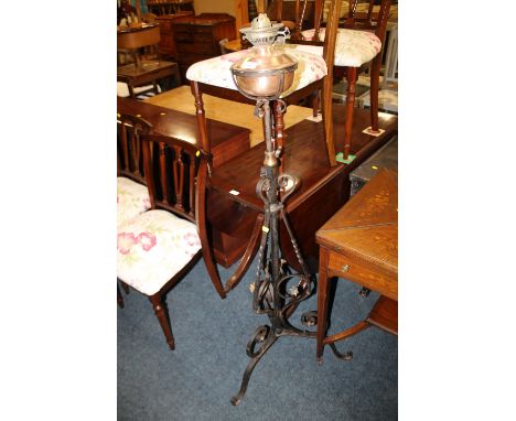 AN ANTIQUE IRON AND COPPER LAMP STANDARD