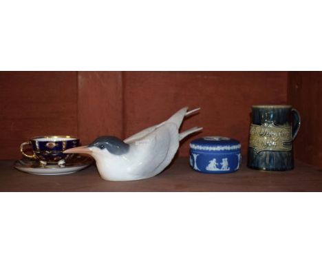 Royal Copenhagen figure of a Tern No.827 together with a Royal Doulton stoneware christening mug with script 'Nora Ethel Durn