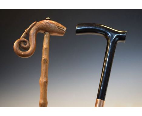 Early 20th Century ebony walking stick having a 9ct gold band together with a rustic walking staff having a Scandinavian carv