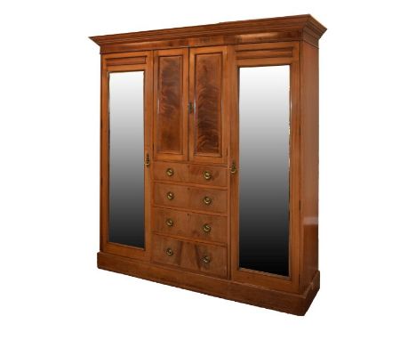 Early 20th Century mahogany and string inlaid three section wardrobe, the central pair of doors enclosing a shelf, the mirror