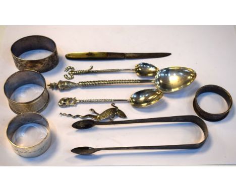 Four silver napkin rings, pair of Georgian sugar tongs, mother-of-pearl silver bladed fruit knife and various white metal spo