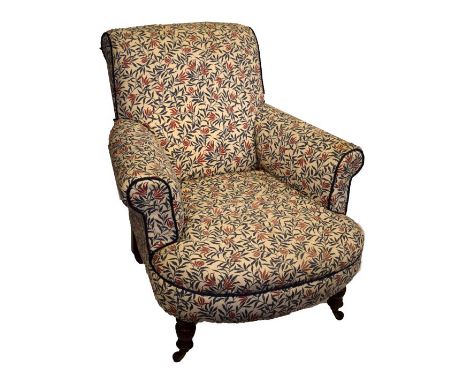 Late Victorian easy armchair raised on turned beech supports fitted ceramic casters having printed cotton floral design uphol