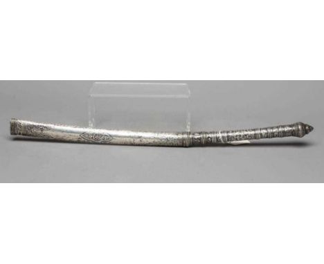 AN INDIAN LONG DAGGER, the 12 1/2" curved blade inscribed with script, white metal grip embossed with foliage, stepped pommel