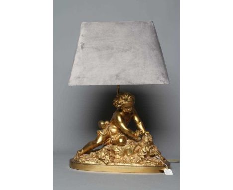 A GILT METAL AND COMPOSITION TABLE LAMP, 20th century, modelled as a cherub on a rocky outcrop surmounted with cornucopia and