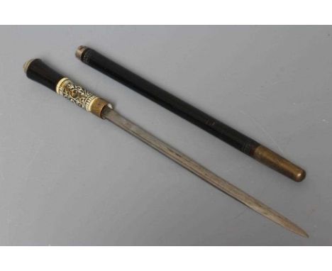 A SWORD SWAGGER STICK, early 20th century, the 14" fullered blade released with twist ferrule, carved bone grip, lion pommel 